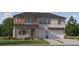 Charming two-story home with stone accents and a three-car garage at 11515 E 69Th Pl, Palmetto, FL 34221