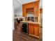 Wet bar features custom cabinetry, wine rack, mini fridge, and countertop space at 1281 Amberlea E Dr, Dunedin, FL 34698