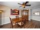 Cozy dining room with a wooden table, four chairs, and a ceiling fan for added comfort at 1281 Amberlea E Dr, Dunedin, FL 34698