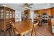 Dining area seamlessly integrates with the kitchen, featuring wood cabinets, stainless steel appliances, and an island at 1281 Amberlea E Dr, Dunedin, FL 34698
