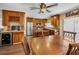 Dining area next to kitchen with wood cabinets, stainless steel appliances, a wine rack, and plenty of counter space at 1281 Amberlea E Dr, Dunedin, FL 34698