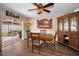 Bright dining room featuring a wooden table, four chairs, and sliding glass doors leading to the patio at 1281 Amberlea E Dr, Dunedin, FL 34698