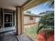 Home featuring a covered front porch with decorative rock and plantings around the foundation at 1281 Amberlea E Dr, Dunedin, FL 34698