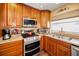 Modern kitchen boasting stainless steel appliances, wood cabinets, and a functional layout for cooking enthusiasts at 1281 Amberlea E Dr, Dunedin, FL 34698