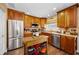 Efficient kitchen featuring stainless steel appliances, wood cabinets, and ample counter space for meal preparation at 1281 Amberlea E Dr, Dunedin, FL 34698