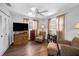 Cozy living room with ample seating, TV, and lots of natural light from two windows at 1281 Amberlea E Dr, Dunedin, FL 34698