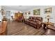 Bright and airy living room with hardwood floors and leather furniture, creating a cozy and inviting atmosphere at 1281 Amberlea E Dr, Dunedin, FL 34698