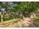 Amberlea Park sign surrounded by lush trees and green space at 1281 Amberlea E Dr, Dunedin, FL 34698