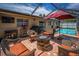 Spacious outdoor patio with fire pit, barbecue, and wicker furniture at 1281 Amberlea E Dr, Dunedin, FL 34698