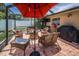 Charming screened patio with brick flooring, fire pit and ample seating at 1281 Amberlea E Dr, Dunedin, FL 34698