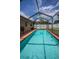 Inviting screened pool with brick trim is perfect for outdoor enjoyment at 1281 Amberlea E Dr, Dunedin, FL 34698