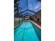 Inviting screened-in pool area with brick-paved patio and ample space for outdoor entertaining at 1281 Amberlea E Dr, Dunedin, FL 34698