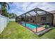 Landscaped backyard with pool, patio, and privacy fence, perfect for outdoor living at 1281 Amberlea E Dr, Dunedin, FL 34698