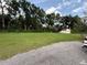 Expansive backyard surrounded by trees and a storage shed at 13400 10Th St, Dade City, FL 33525