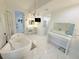 Primary bathroom showcasing a modern tub, vanity, chandelier, and ample space at 13400 10Th St, Dade City, FL 33525