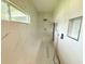 Luxurious bathroom featuring a spacious marble shower with a built-in bench and modern fixtures at 13400 10Th St, Dade City, FL 33525