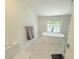 Bright bathroom showcases a freestanding tub, a large window, and modern tile for a spa-like experience at 13400 10Th St, Dade City, FL 33525