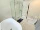 Modern bathroom featuring a freestanding tub, a glass-enclosed shower, and sleek fixtures at 13400 10Th St, Dade City, FL 33525