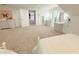 Bright bedroom boasts plenty of space, an ensuite bathroom, and easy access to other rooms at 13400 10Th St, Dade City, FL 33525