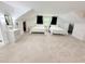 Large bedroom with white walls and two beds separated by a sink and mirror at 13400 10Th St, Dade City, FL 33525