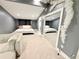 Open concept bedroom with two beds, a mirrored closet, and cloud decorations at 13400 10Th St, Dade City, FL 33525