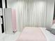 Cozy bedroom features black-and-white striped accents, pink bed, and modern wardrobe at 13400 10Th St, Dade City, FL 33525