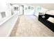 Bright bonus room with neutral carpet, black sofa and modern decor at 13400 10Th St, Dade City, FL 33525