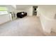 Bright bonus room featuring neutral carpet, a modern sofa, and plenty of space for flexible living at 13400 10Th St, Dade City, FL 33525