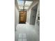 Bright foyer with elegant chandelier, contemporary front door, and views of the skylight at 13400 10Th St, Dade City, FL 33525