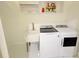 Bright laundry room with modern washer and dryer units and a utility sink at 13400 10Th St, Dade City, FL 33525