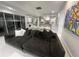 Spacious living room with modern sofa, artwork, and connecting open-concept kitchen and dining area at 13400 10Th St, Dade City, FL 33525
