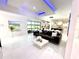 Bright living room with modern furniture, adjacent kitchen, and large windows offering natural light at 13400 10Th St, Dade City, FL 33525