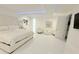 Spacious main bedroom with white decor, seating area, and ample natural light at 13400 10Th St, Dade City, FL 33525