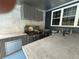 Outdoor kitchen with stainless steel appliances, concrete counters and cabinetry at 13400 10Th St, Dade City, FL 33525