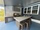 Modern outdoor kitchen with concrete counters, stainless steel appliances and bar seating at 13400 10Th St, Dade City, FL 33525