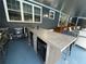 Outdoor kitchen with concrete counters, a sink, wine cooler, and bar seating at 13400 10Th St, Dade City, FL 33525