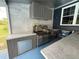 Modern outdoor kitchen with stainless steel appliances and a concrete countertop at 13400 10Th St, Dade City, FL 33525