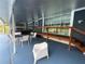 Spacious covered patio featuring a dining table, grill, and sliding glass doors at 13400 10Th St, Dade City, FL 33525
