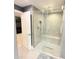 Modern bathroom featuring glass shower with patterned tile and built-in bench at 13400 10Th St, Dade City, FL 33525
