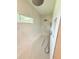 Spacious shower with sleek fixtures, a built-in seat, and modern stone design at 13400 10Th St, Dade City, FL 33525
