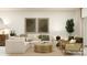 Stylish living room with a comfortable sofa, rattan accents, and a well-lit ambiance at 13535 White Gold Run, Parrish, FL 34219
