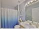 Cozy bathroom with a single vanity, toilet, and blue-themed shower curtain at 13750 Fareham Rd, Odessa, FL 33556