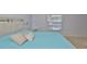 Comfortable bedroom featuring a light blue comforter and modern sliding barn door headboard at 13750 Fareham Rd, Odessa, FL 33556