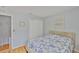Bedroom with light blue walls, wood flooring, and a comfortable bed at 13750 Fareham Rd, Odessa, FL 33556