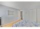 Bedroom featuring light blue walls, wood flooring, and closet space at 13750 Fareham Rd, Odessa, FL 33556
