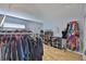 Spacious walk-in closet with wood floors, ample hanging space and shoe storage at 13750 Fareham Rd, Odessa, FL 33556