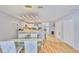 Open-concept dining room and kitchen includes a glass table with chairs and tile and wood flooring at 13750 Fareham Rd, Odessa, FL 33556
