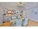 The dining room and kitchen combo includes a glass table, starfish chairs, and bright white cabinets at 13750 Fareham Rd, Odessa, FL 33556