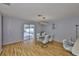 Bright dining room featuring wood floors, a modern table, and a sliding glass door leading to the pool at 13750 Fareham Rd, Odessa, FL 33556