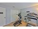 Exercise room equipped with workout machines, hardwood floors, and a mirrored closet at 13750 Fareham Rd, Odessa, FL 33556